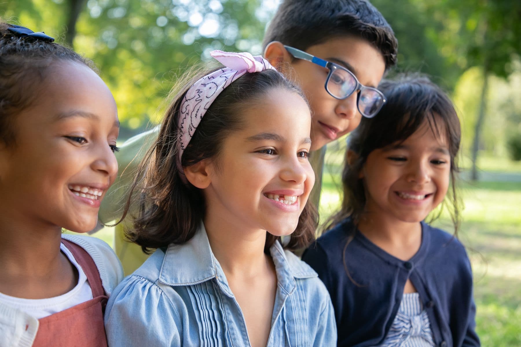 Children laughing together outdoors in the sunshine