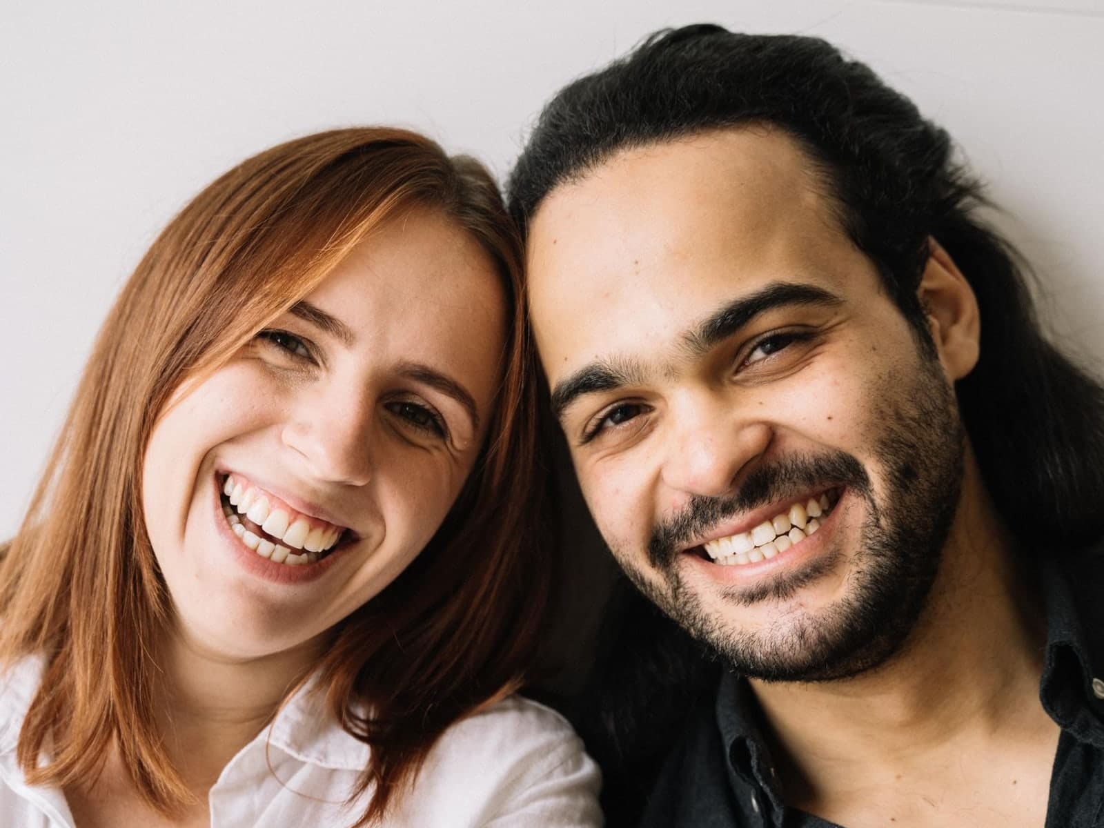 A man and a woman smiling broadly, side by side